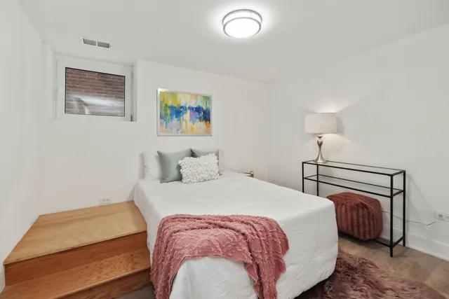 a bedroom with a bed and a lamp