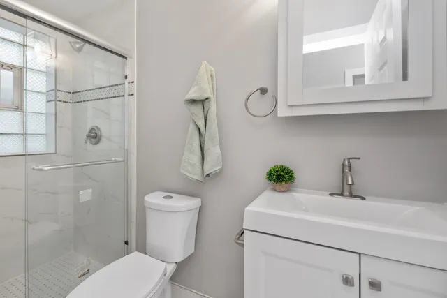a bathroom with a toilet sink and shower