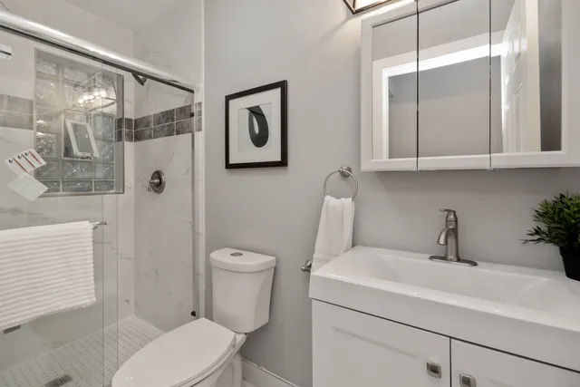 a bathroom with a toilet sink and shower