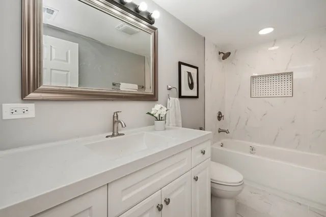 a bathroom with a sink a toilet and a bathtub
