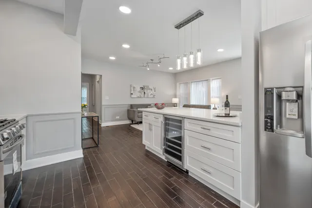 a kitchen with a white stove cabinets and wooden floor