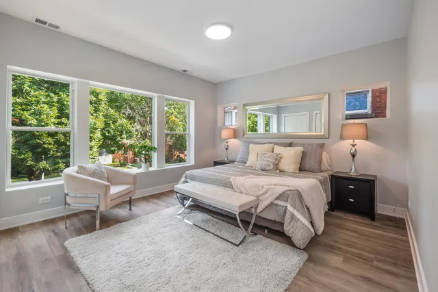 a spacious bedroom with a large bed and a large window