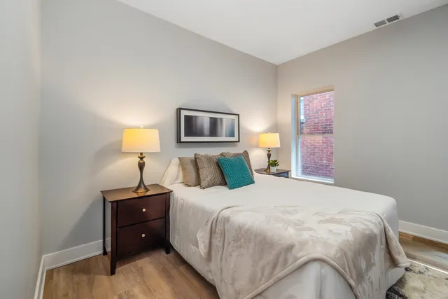 a bedroom with a bed and a lamp