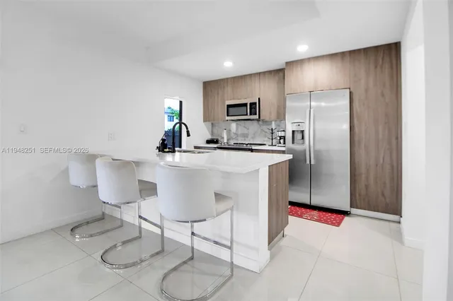 a kitchen with a sink appliances and cabinets