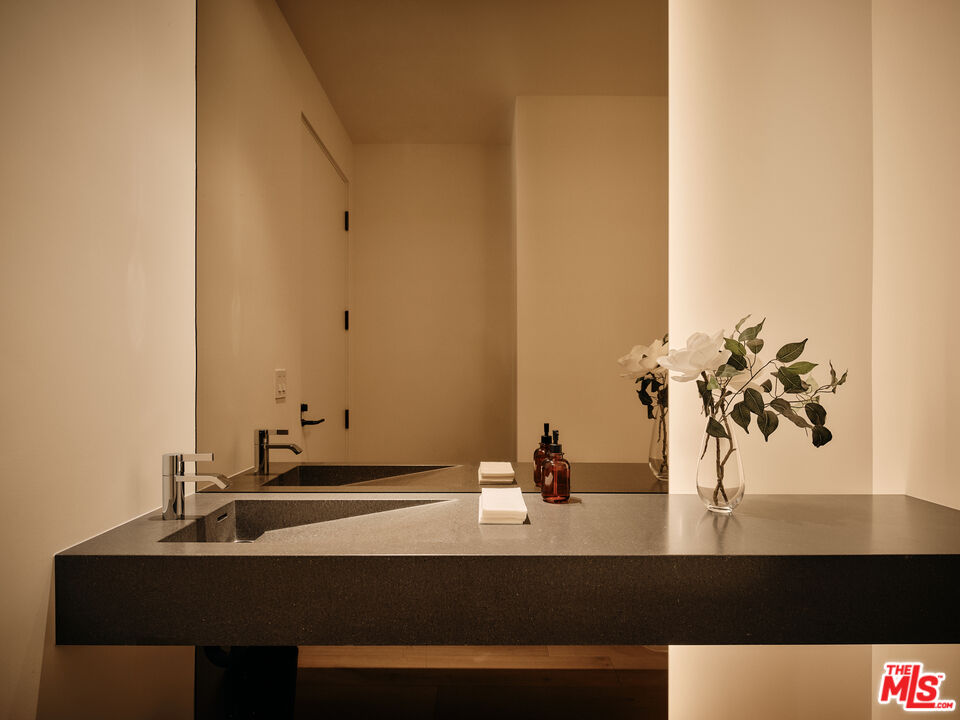 8899 Beverly Boulevard, Unit 8C Los Angeles, CA 90048 - Photo 11 of 33 a view of bathroom with a sink and a mirror
