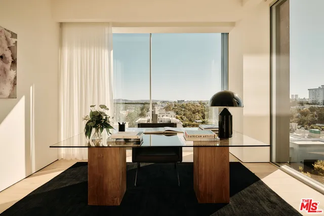 a kitchen with sink and view of living room