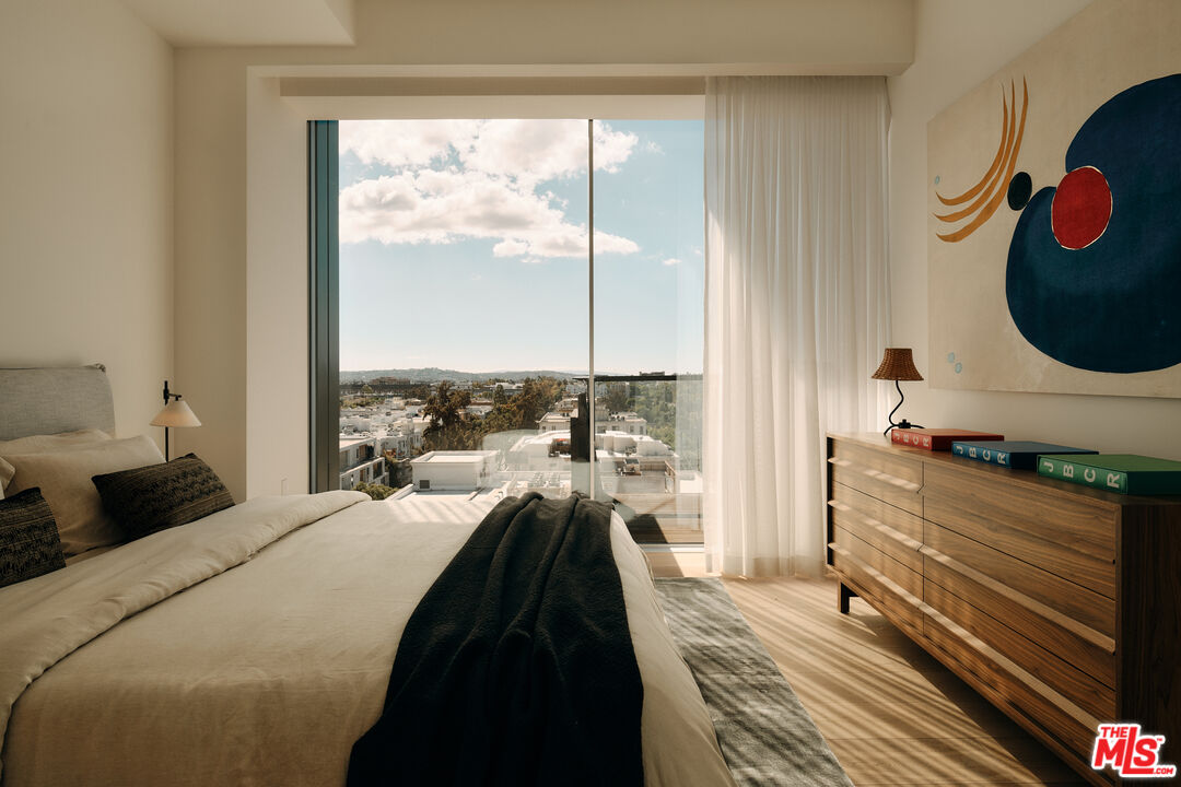 8899 Beverly Boulevard, Unit 8C Los Angeles, CA 90048 - Photo 17 of 33 a bedroom with a bed and a large window