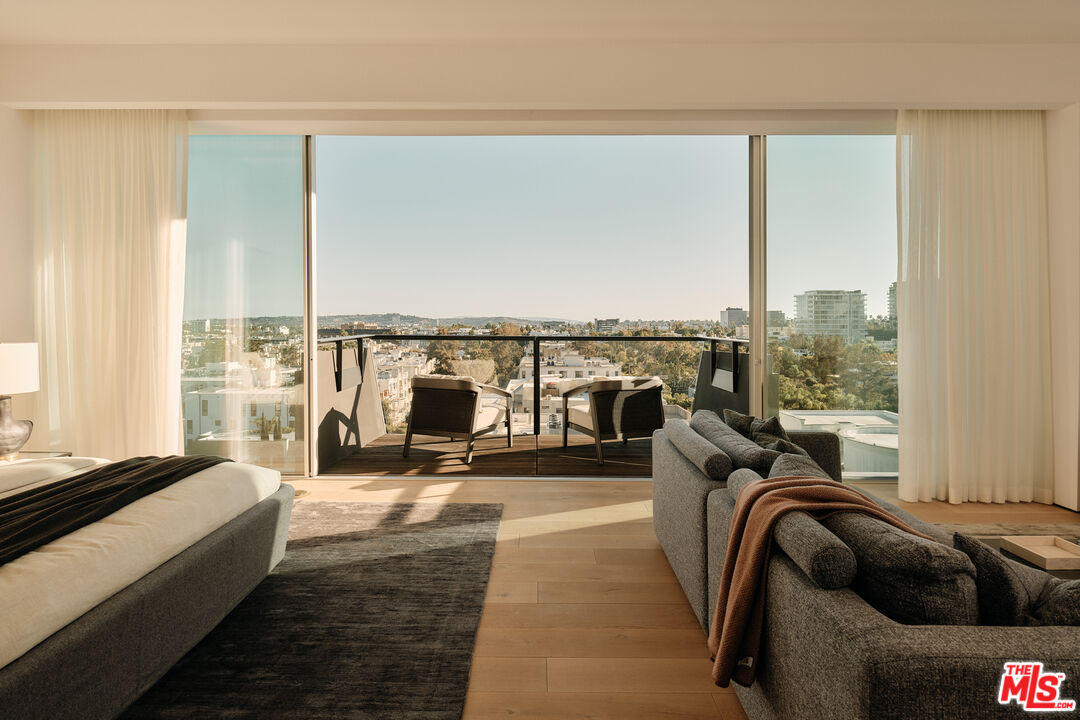 8899 Beverly Boulevard, Unit 8C Los Angeles, CA 90048 - Photo 18 of 33 a living room with furniture and floor to ceiling windows