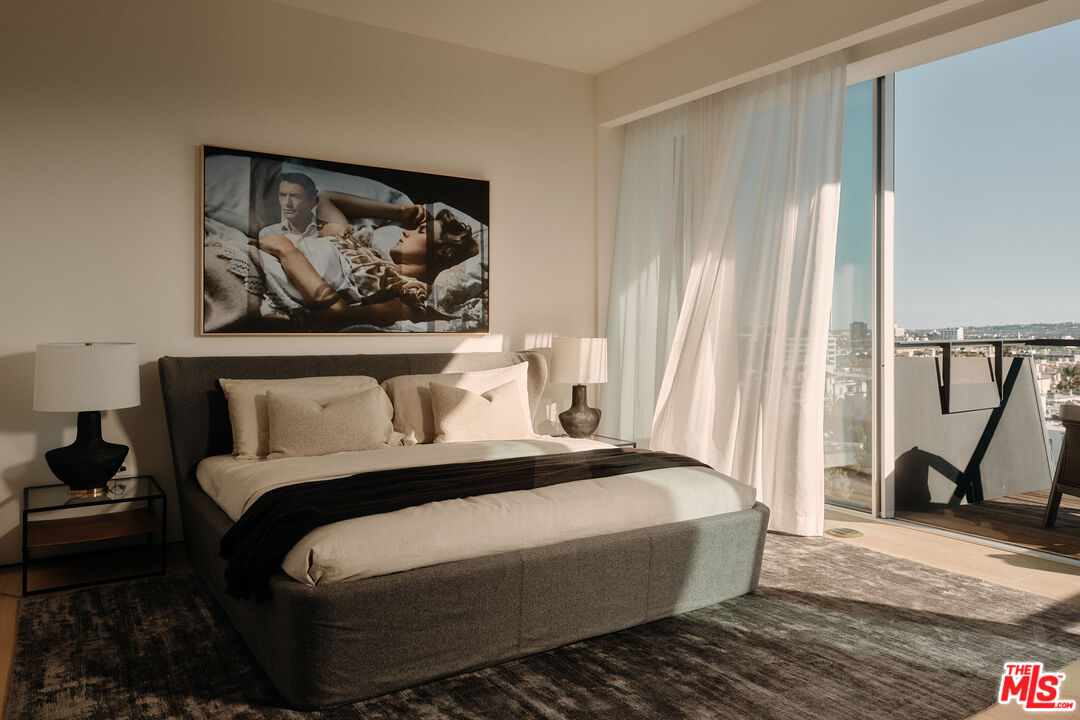 8899 Beverly Boulevard, Unit 8C Los Angeles, CA 90048 - Photo 24 of 33 a bedroom with a bed and a painting on the wall