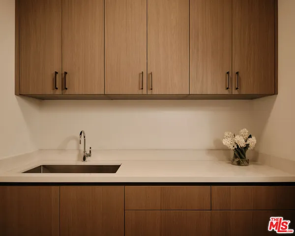 a bathroom with a sink and cabinets