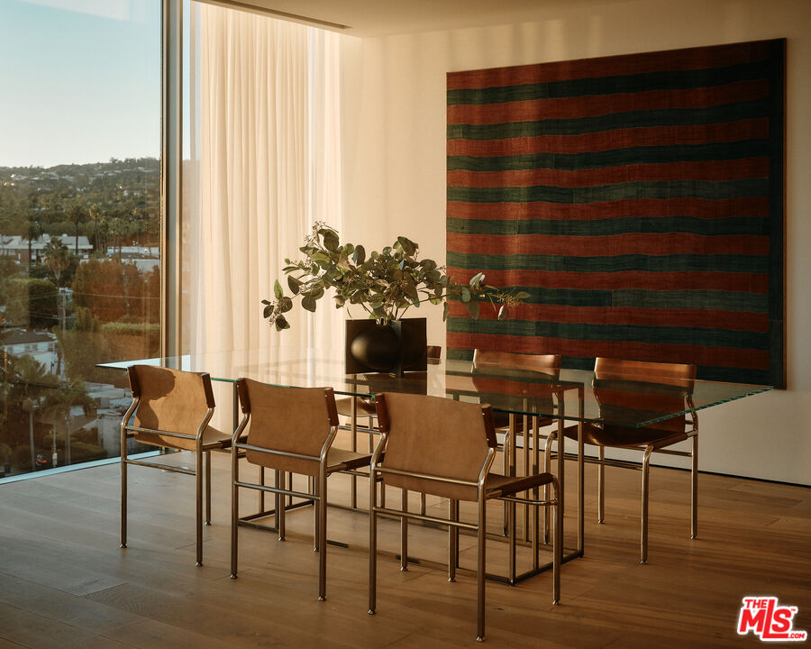 8899 Beverly Boulevard, Unit 8C Los Angeles, CA 90048 - Photo 7 of 33 a dining room with furniture and wooden floor