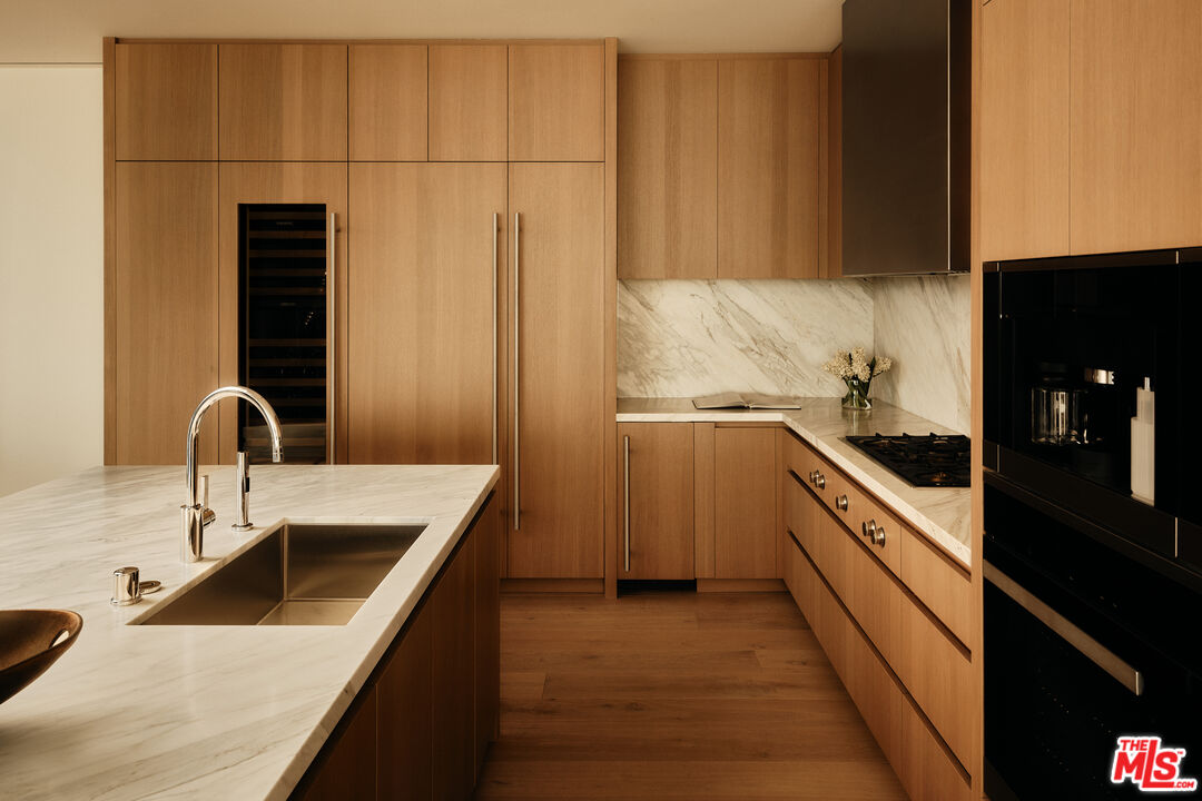 8899 Beverly Boulevard, Unit 8C Los Angeles, CA 90048 - Photo 8 of 33 a kitchen with stainless steel appliances a sink and a stove