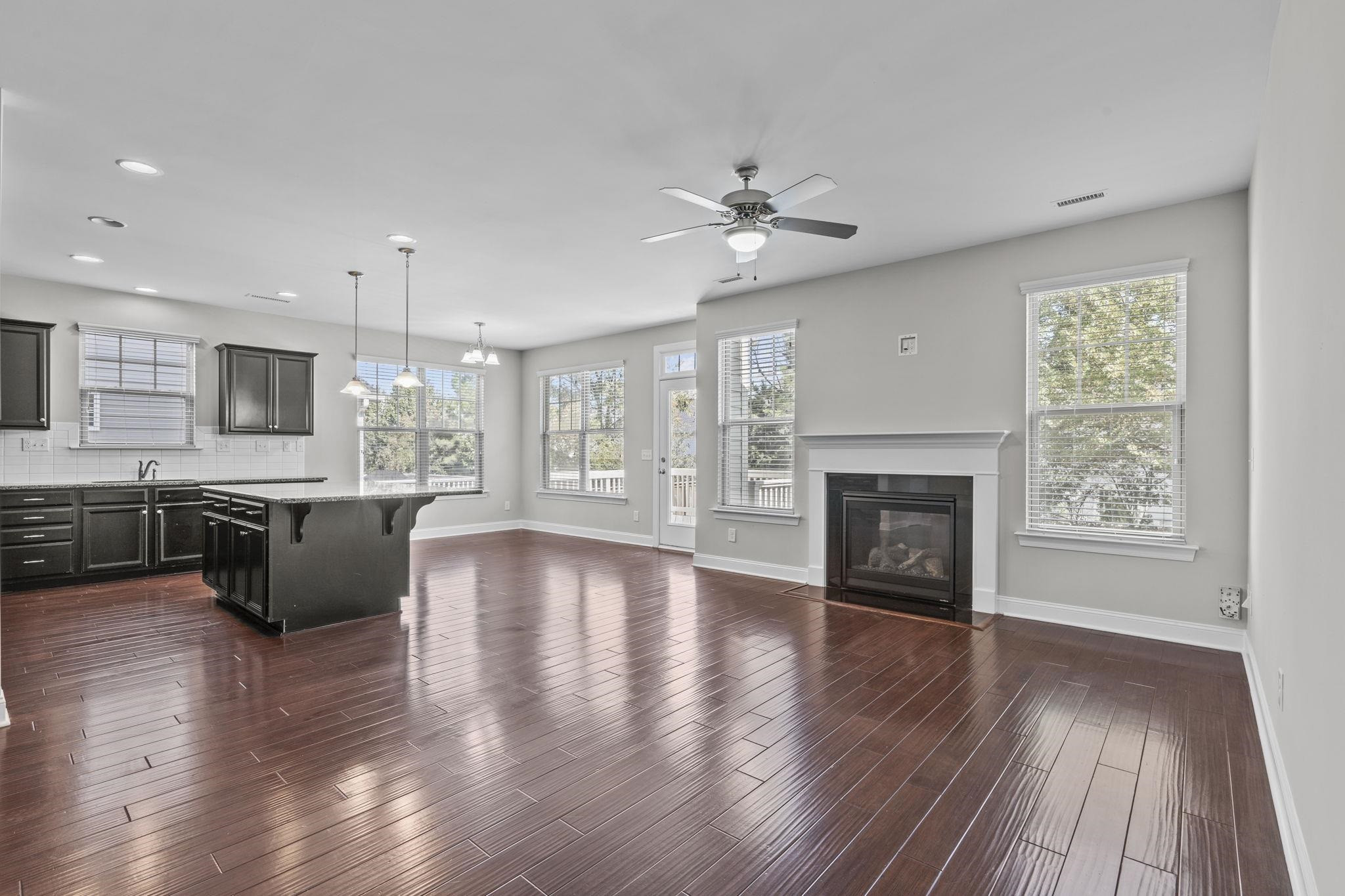 4240 Rockdell Hall Street Raleigh, NC 27616 - Photo 11 of 39 a view of an empty room with a kitchen and a fireplace