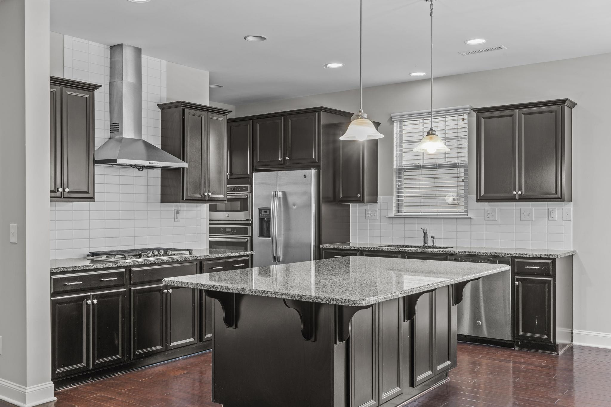 4240 Rockdell Hall Street Raleigh, NC 27616 - Photo 14 of 39 a kitchen with stainless steel appliances granite countertop a stove a sink and a refrigerator
