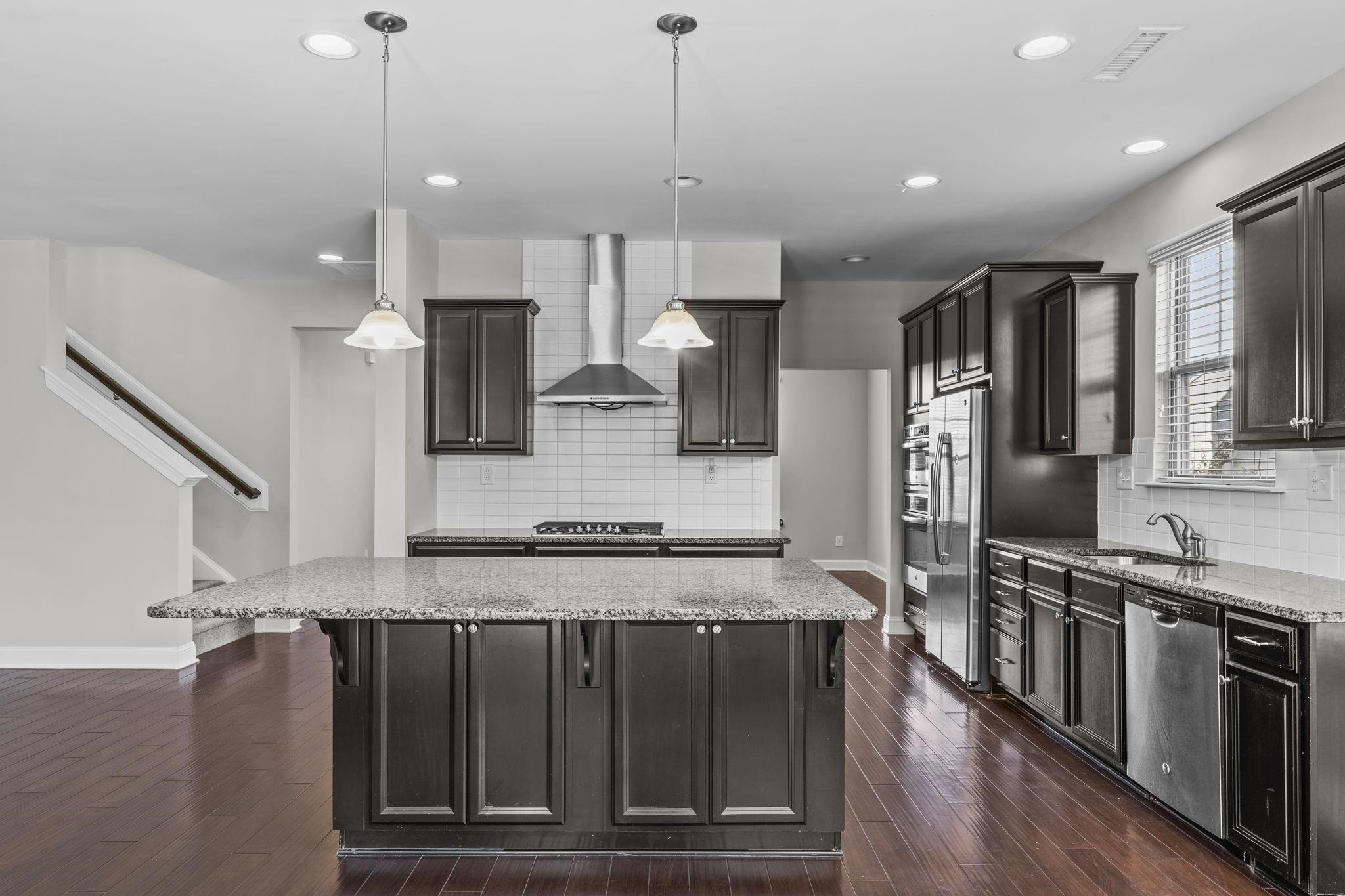4240 Rockdell Hall Street Raleigh, NC 27616 - Photo 15 of 39 a kitchen with stainless steel appliances granite countertop a stove a sink and a refrigerator