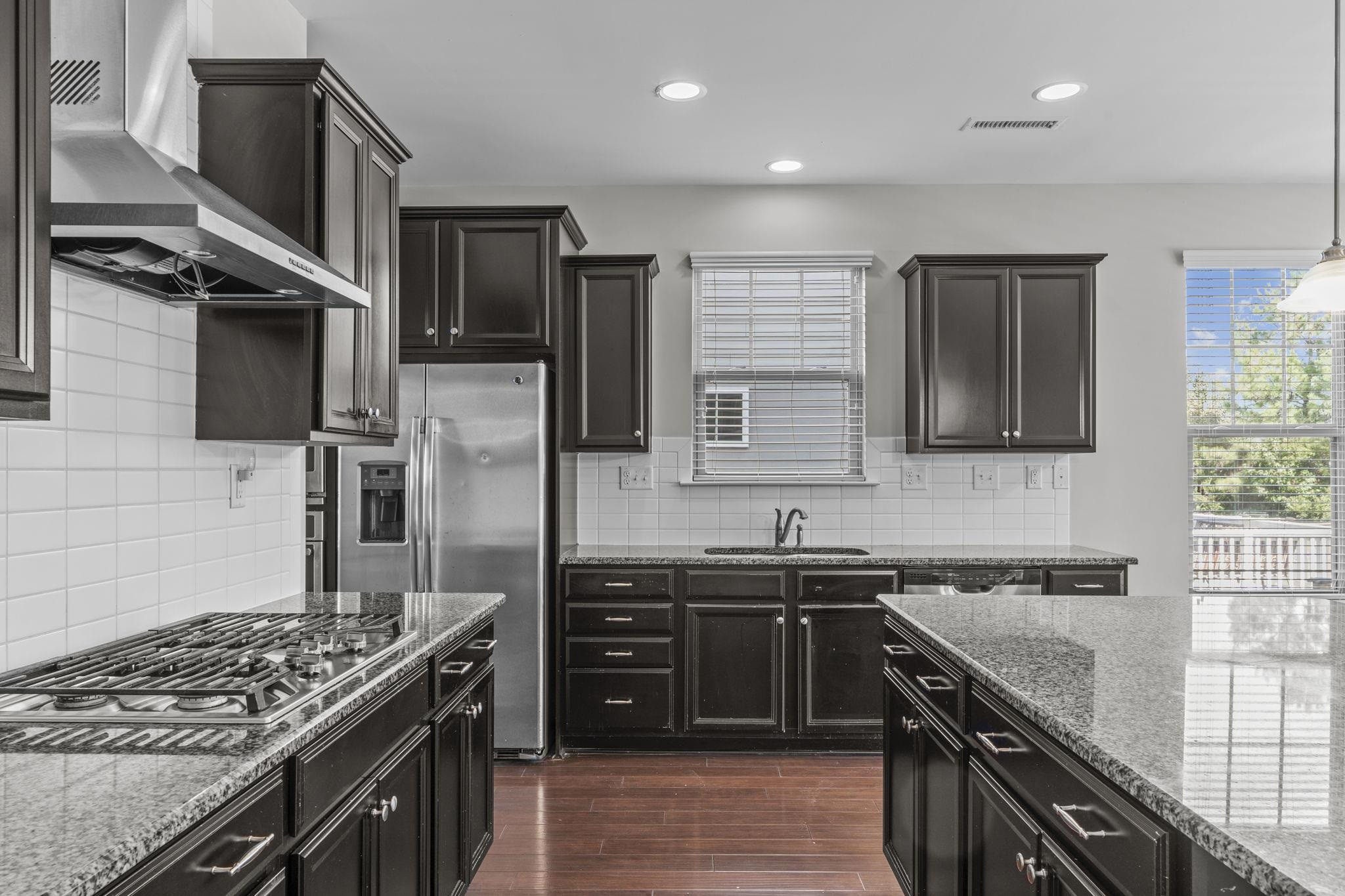 4240 Rockdell Hall Street Raleigh, NC 27616 - Photo 16 of 39 a kitchen with stainless steel appliances granite countertop a sink stove and refrigerator