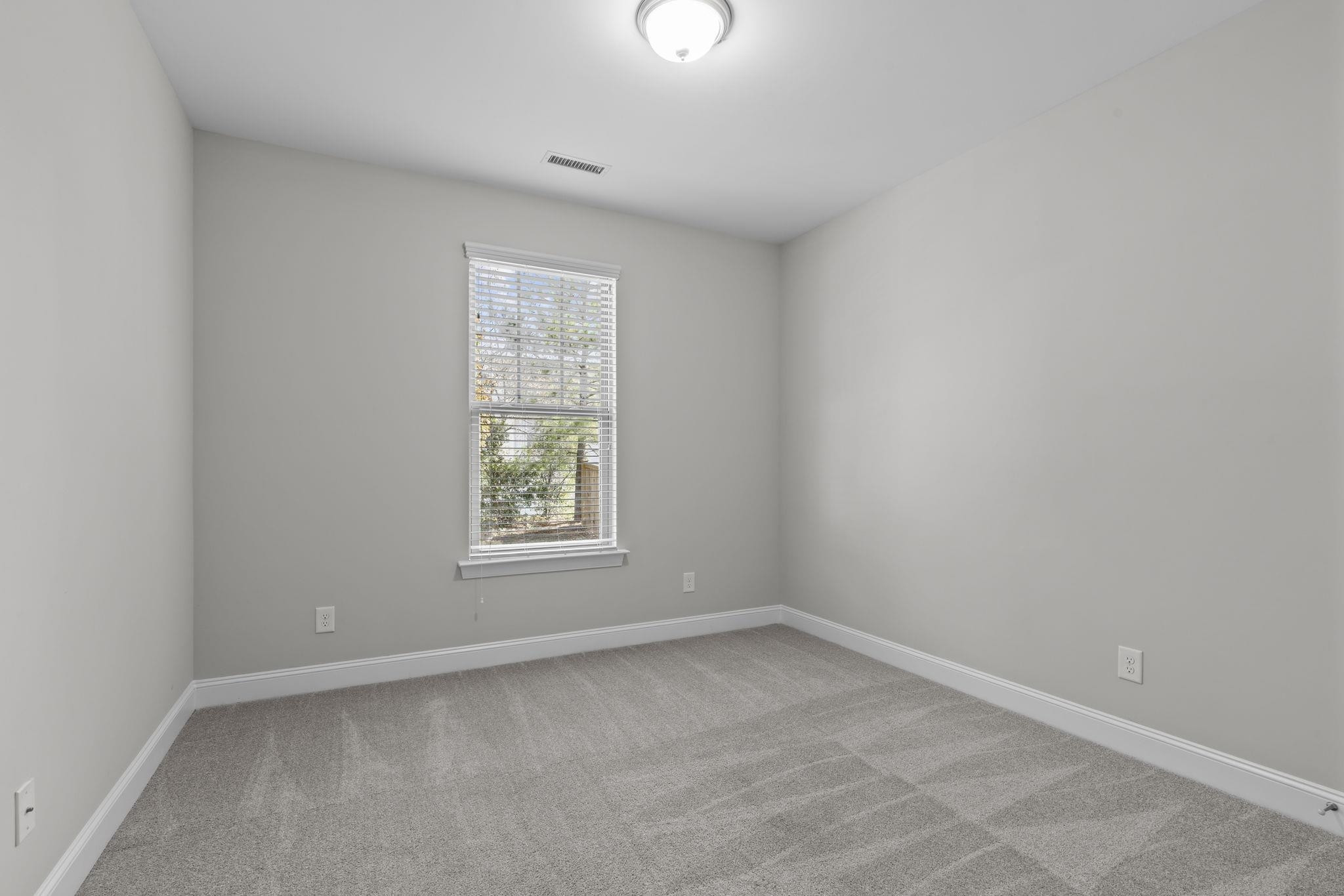 4240 Rockdell Hall Street Raleigh, NC 27616 - Photo 18 of 39 an empty room with a window
