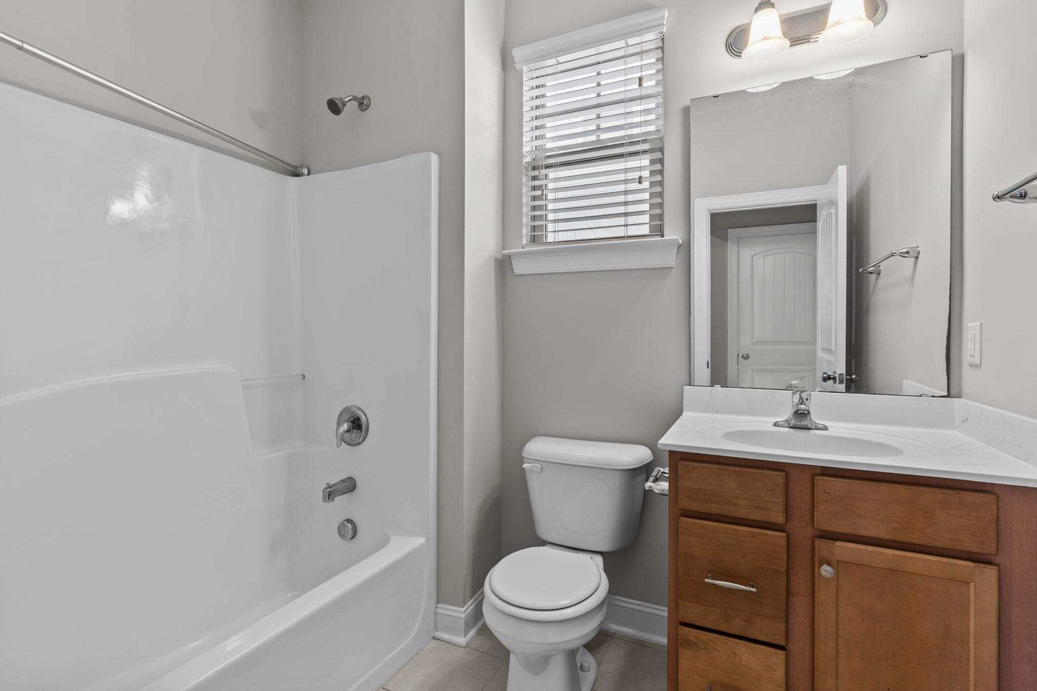 4240 Rockdell Hall Street Raleigh, NC 27616 - Photo 20 of 39 a bathroom with a sink toilet vanity and shower