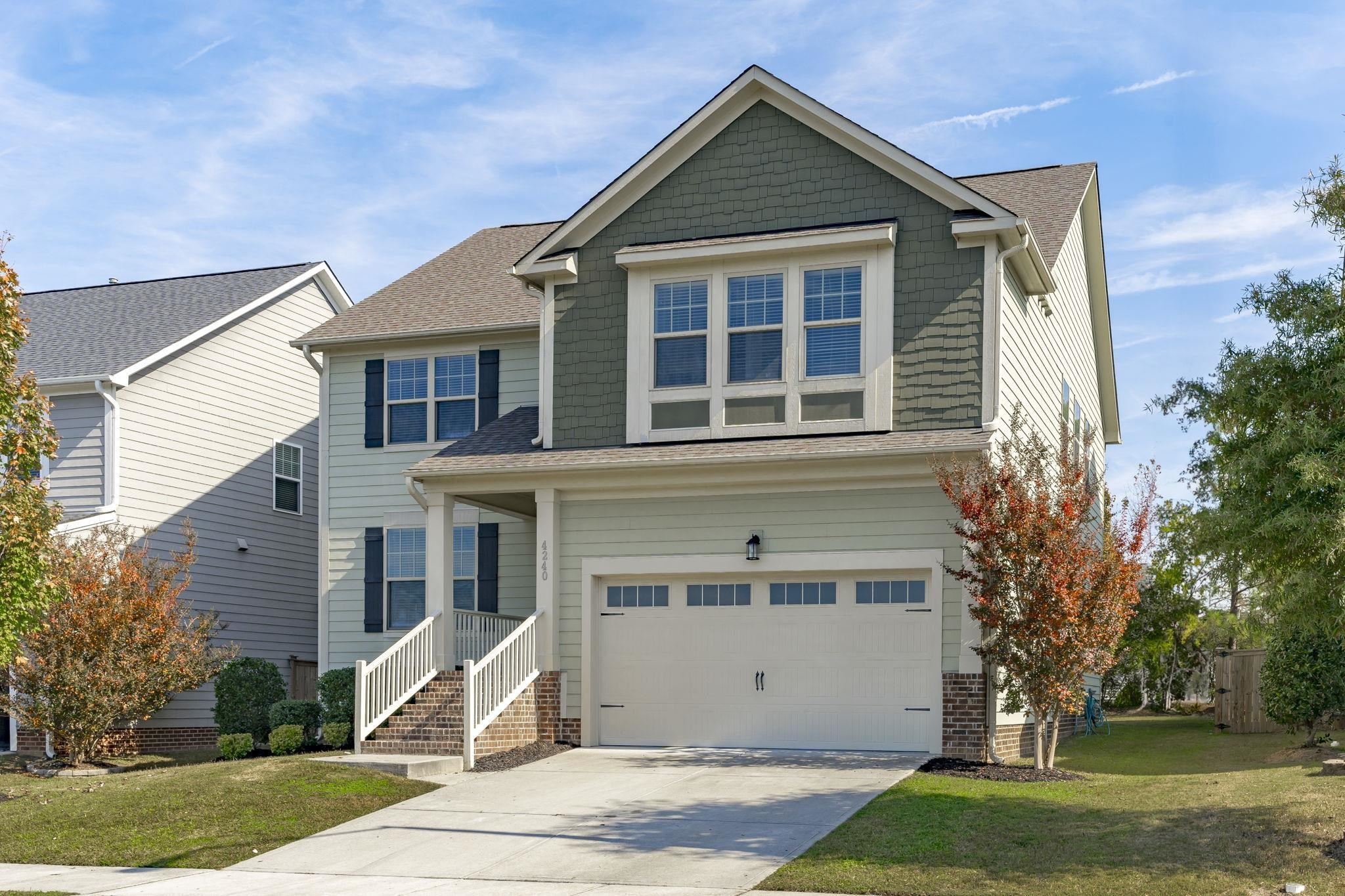 4240 Rockdell Hall Street Raleigh, NC 27616 - Photo 2 of 39 a front view of a house with a yard and garage