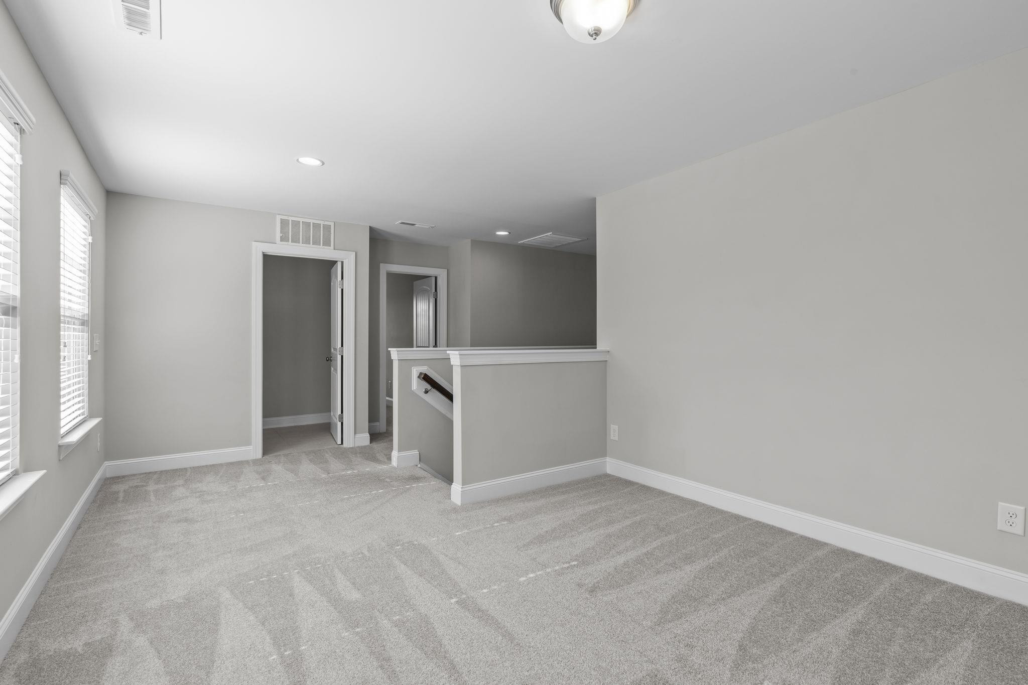 4240 Rockdell Hall Street Raleigh, NC 27616 - Photo 23 of 39 an empty room with a empty space and windows
