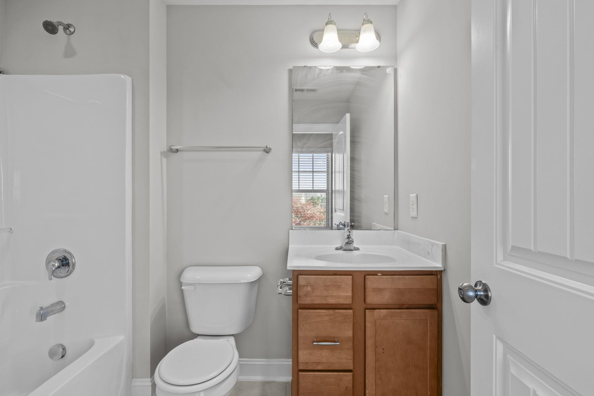 4240 Rockdell Hall Street Raleigh, NC 27616 - Photo 27 of 39 a bathroom with a granite countertop sink a toilet and shower