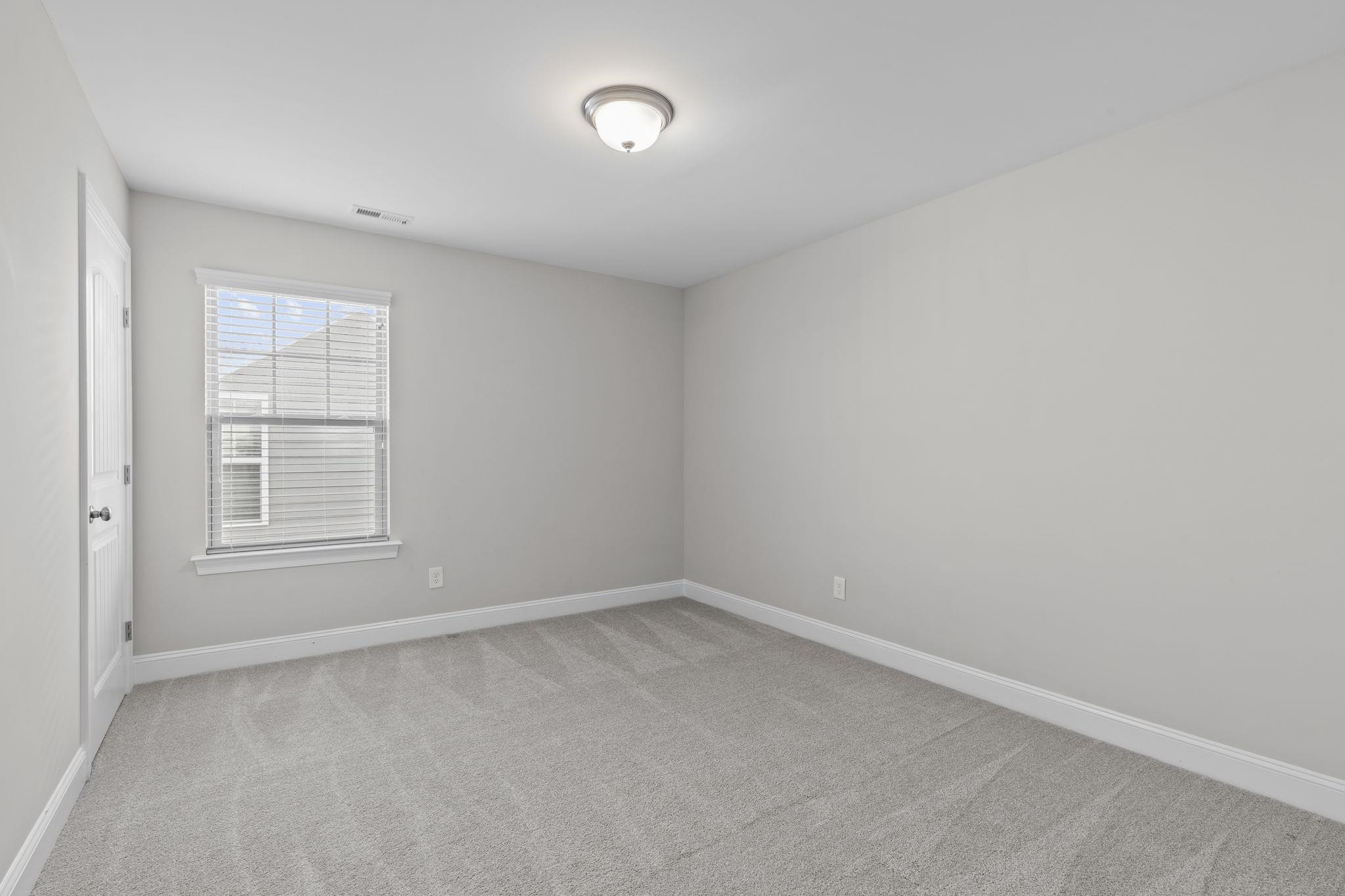 4240 Rockdell Hall Street Raleigh, NC 27616 - Photo 31 of 39 an empty room with a window