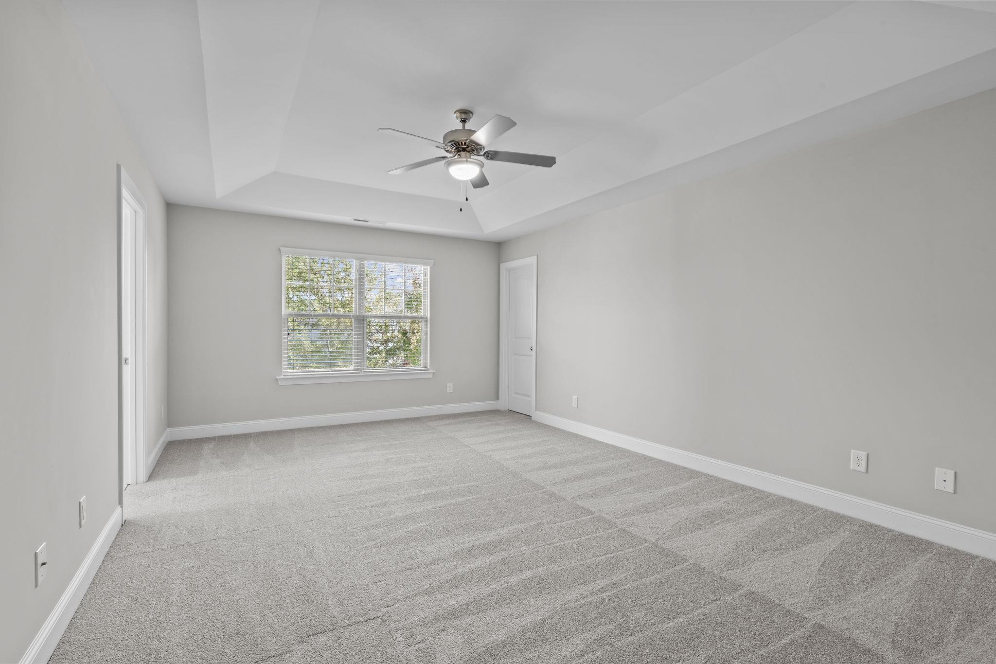 4240 Rockdell Hall Street Raleigh, NC 27616 - Photo 32 of 39 an empty room with windows and fan