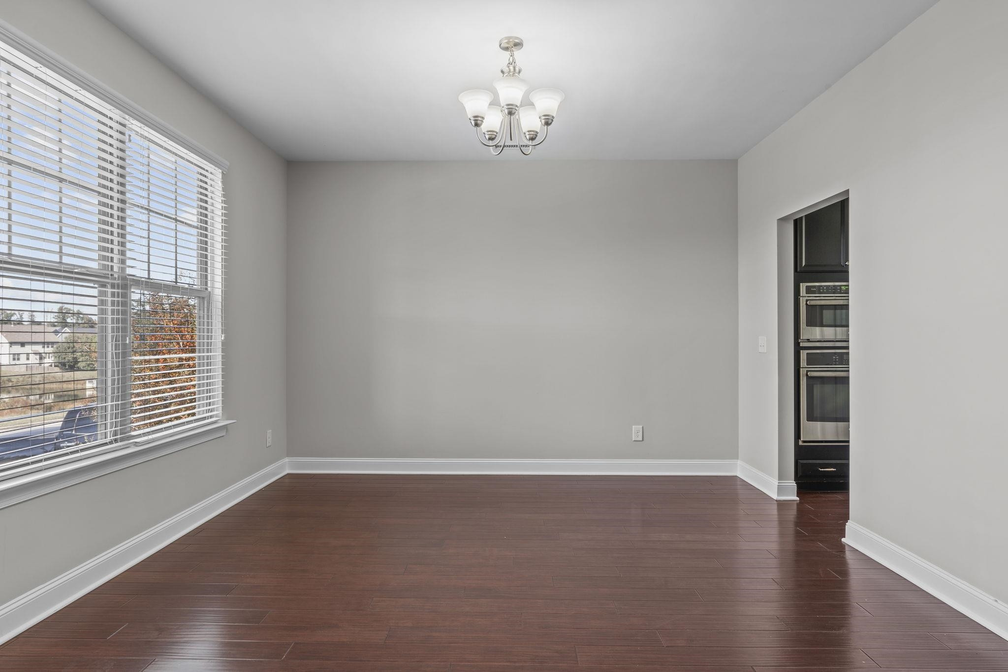 4240 Rockdell Hall Street Raleigh, NC 27616 - Photo 7 of 39 wooden floor in an empty room with a window