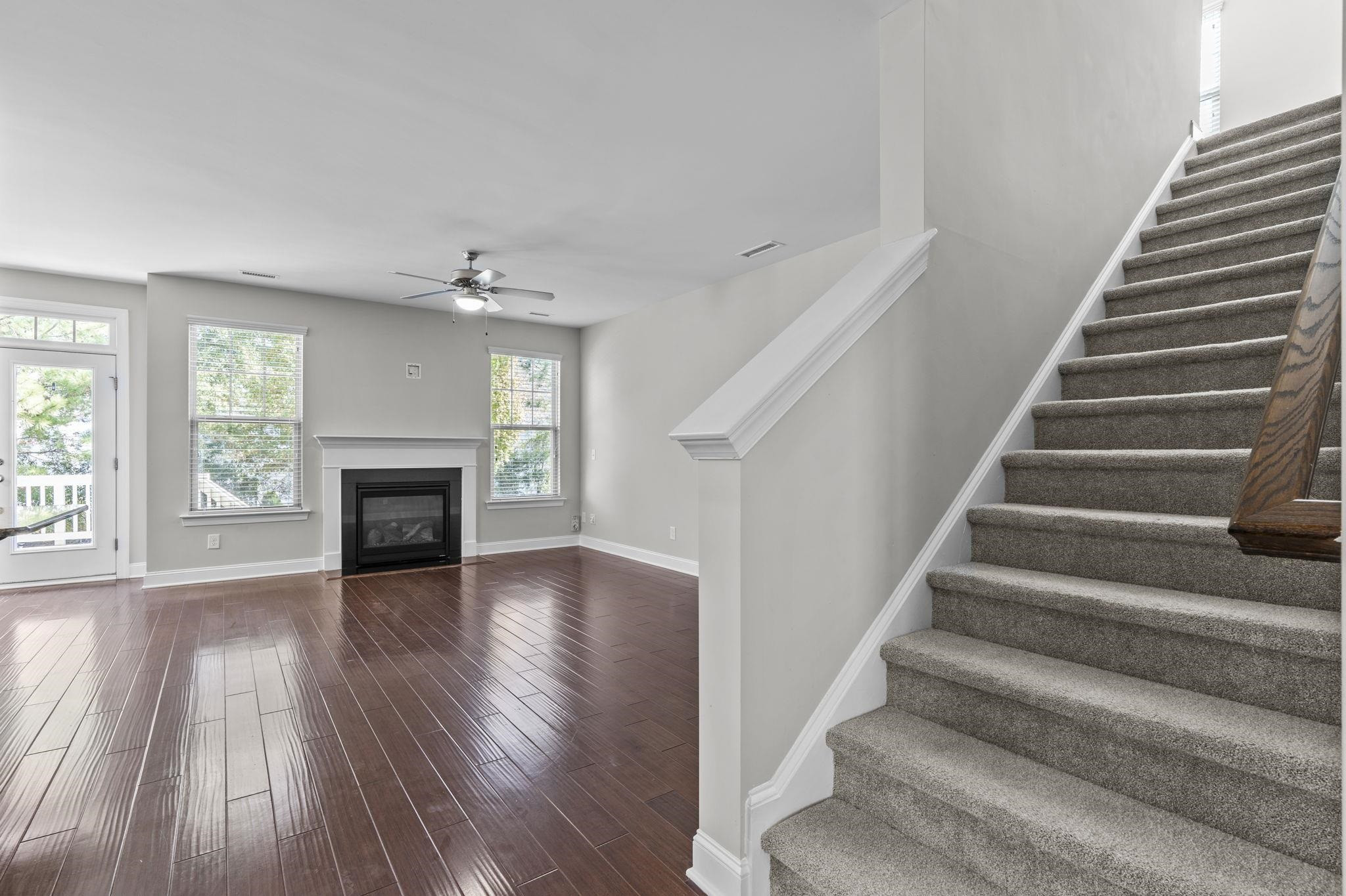 4240 Rockdell Hall Street Raleigh, NC 27616 - Photo 9 of 39 a view of an empty room with wooden floor fireplace and windows