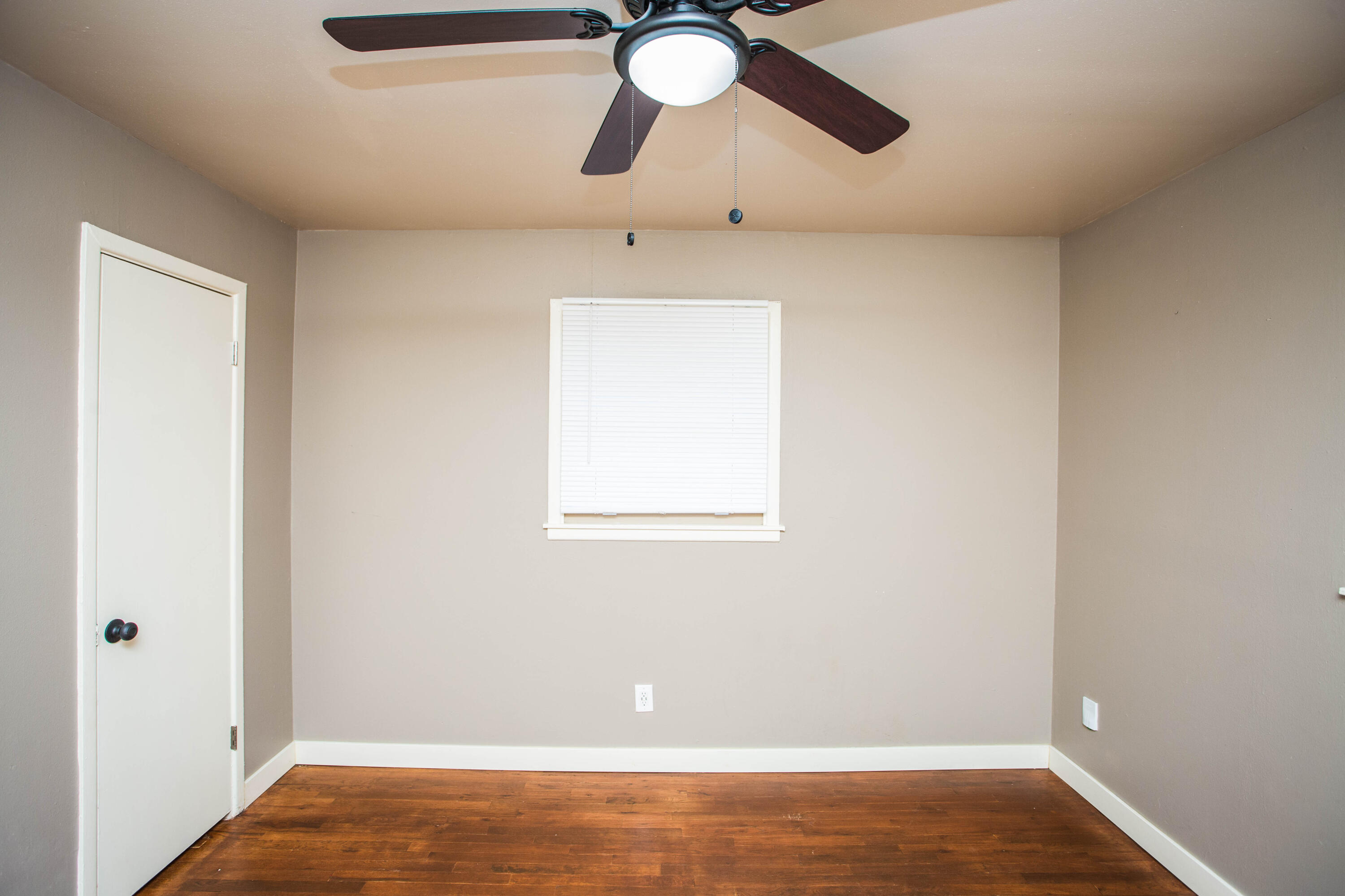4402 29th Street, Unit B Lubbock, TX 79410 - Photo 12 of 23 a view of room with hardwood floor and ceiling fan