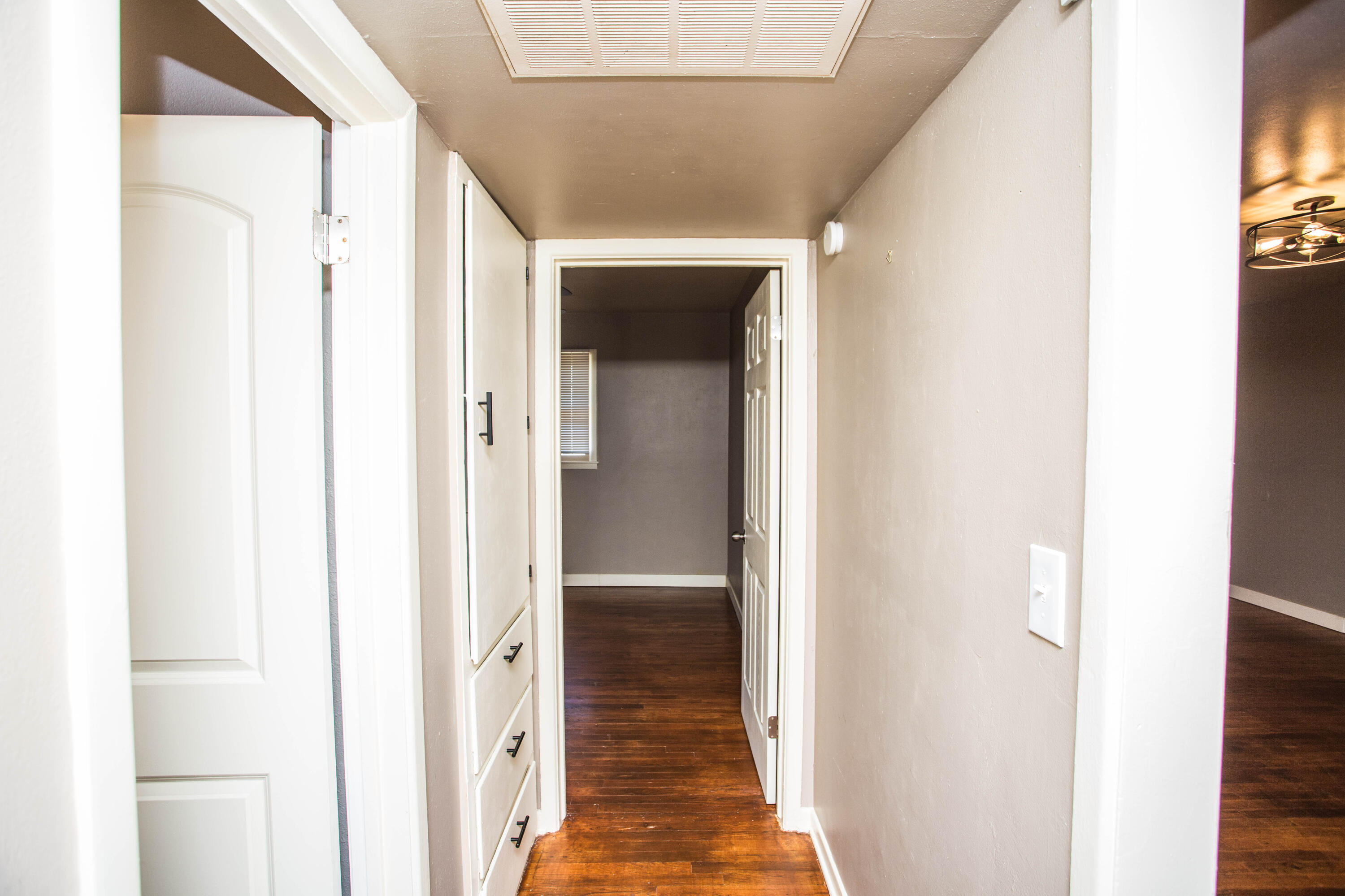 4402 29th Street, Unit B Lubbock, TX 79410 - Photo 14 of 23 a view of a hallway with wooden floor