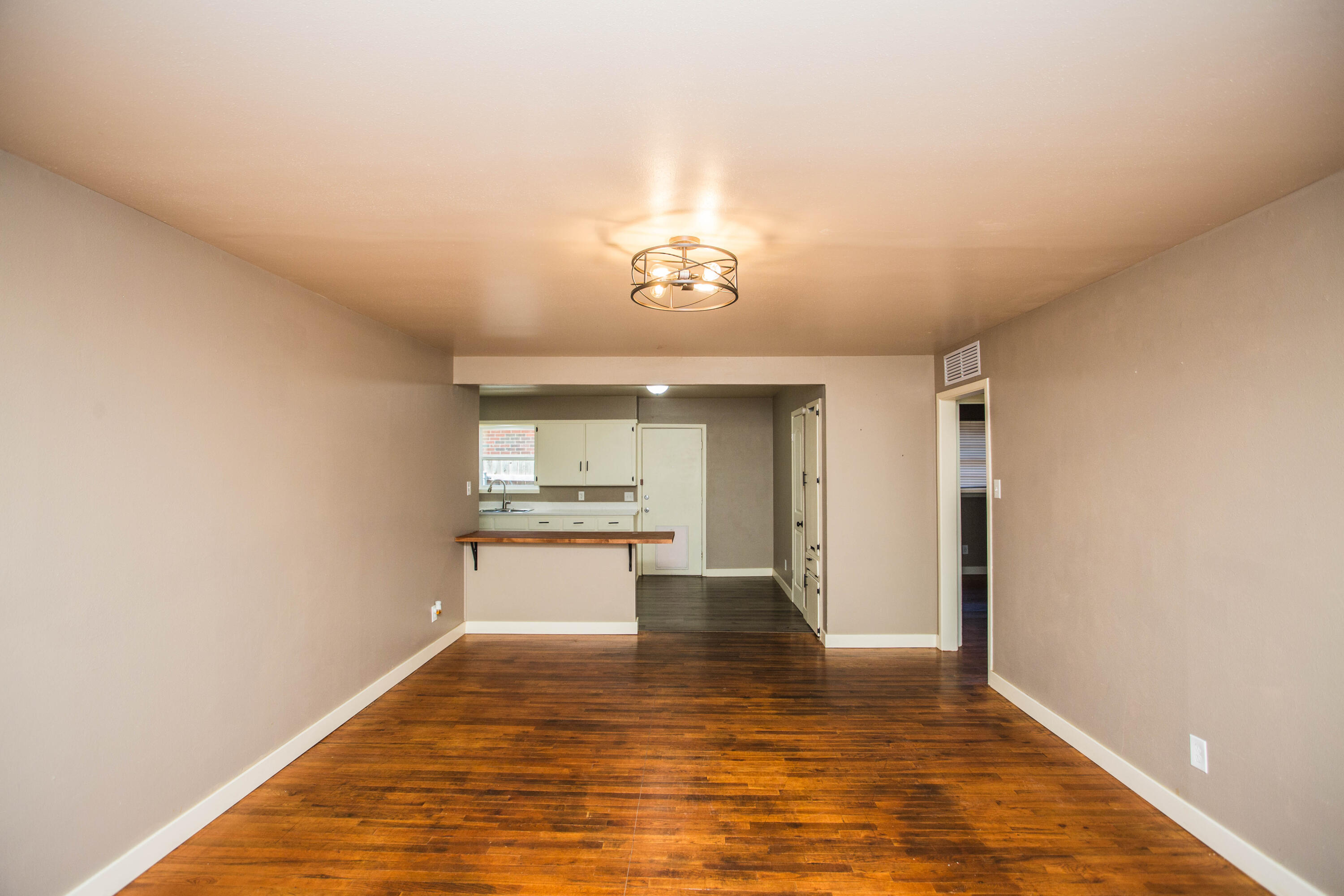 4402 29th Street, Unit B Lubbock, TX 79410 - Photo 2 of 23 a view of a kitchen with a sink and a stove