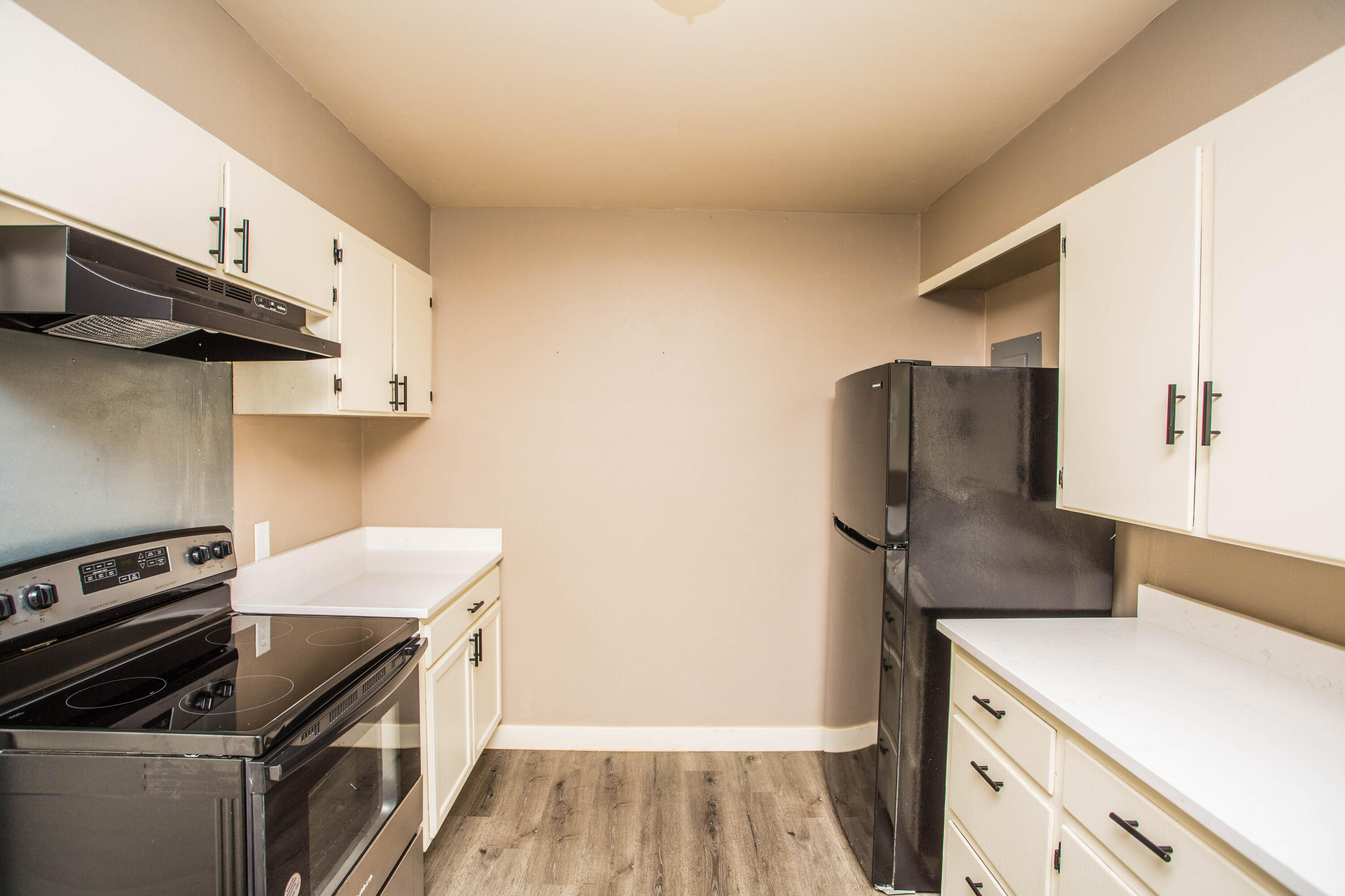 4402 29th Street, Unit B Lubbock, TX 79410 - Photo 5 of 23 a kitchen with a stove and a refrigerator