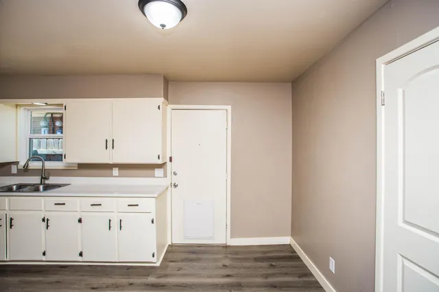 a spacious bathroom with a double vanity sink and mirror
