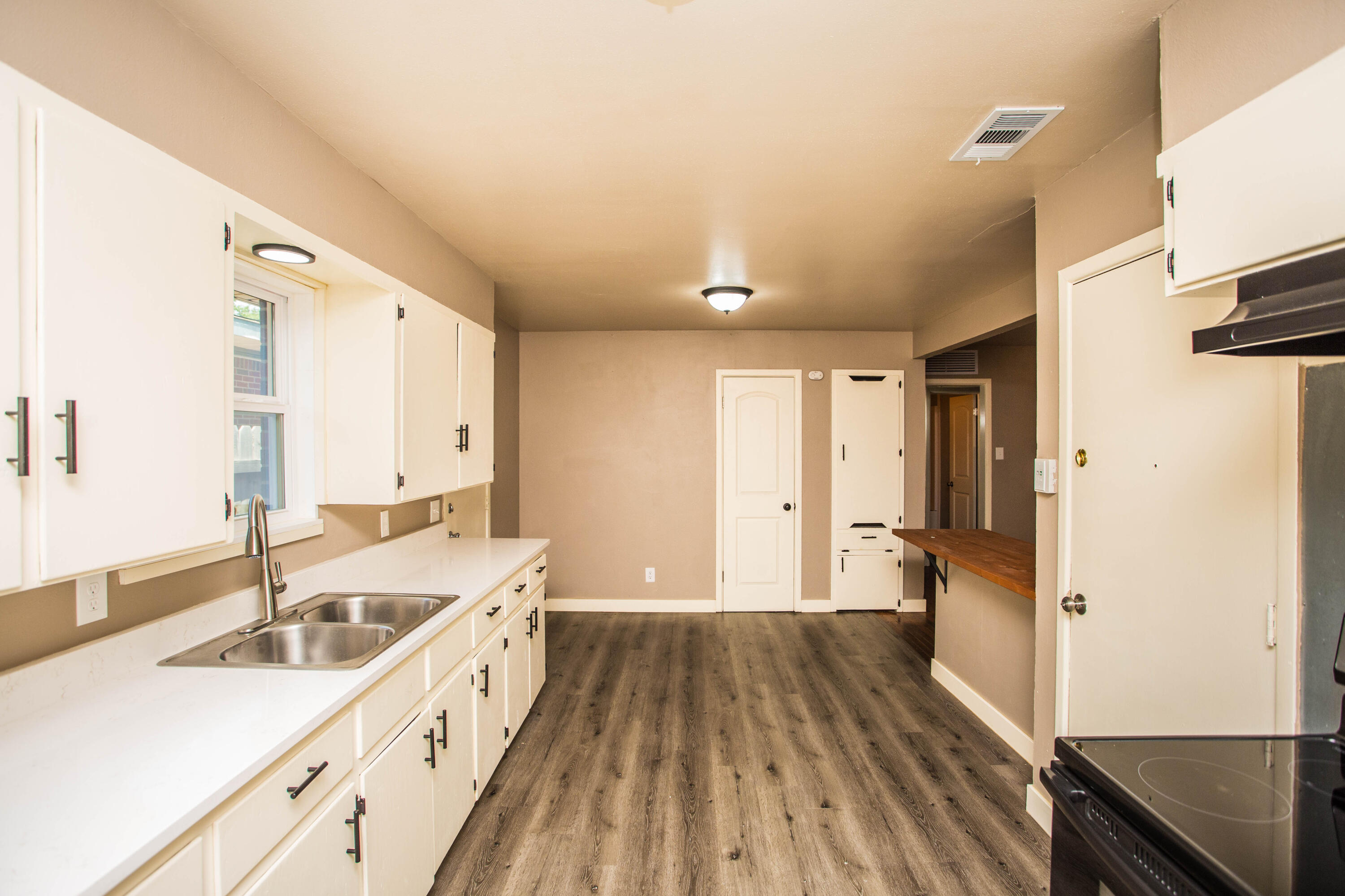 4402 29th Street, Unit B Lubbock, TX 79410 - Photo 9 of 23 a spacious bathroom with a double vanity sink and mirror
