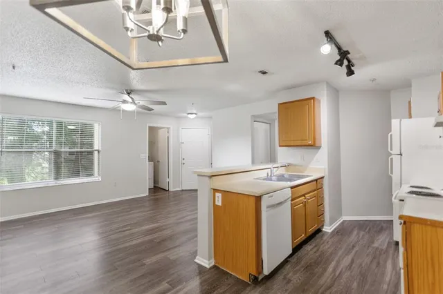 a kitchen with stainless steel appliances granite countertop a stove and a refrigerator