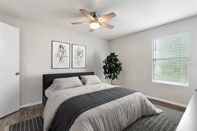 a bedroom with a large bed and a window