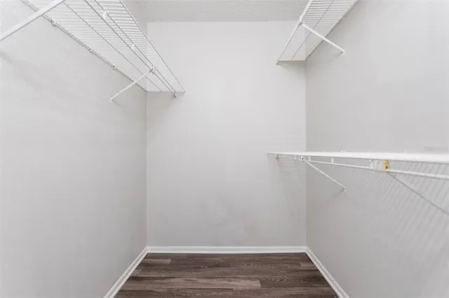 a view of walk in closet with empty racks