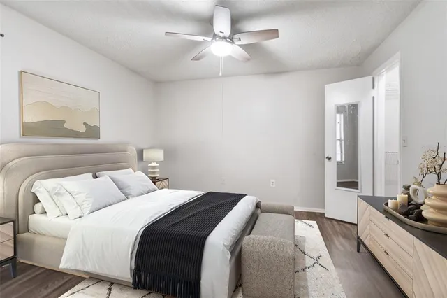 a bedroom with a white bed and a chandelier