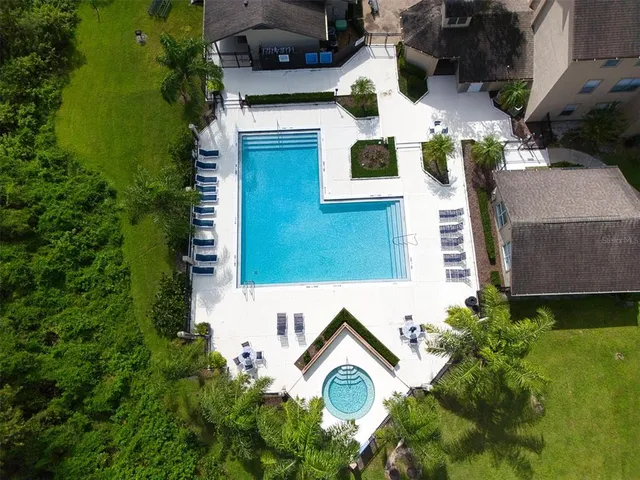 a view of white house with a yard and potted plants