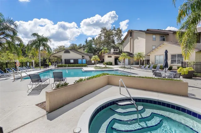 a view of a house with swimming pool and furniture