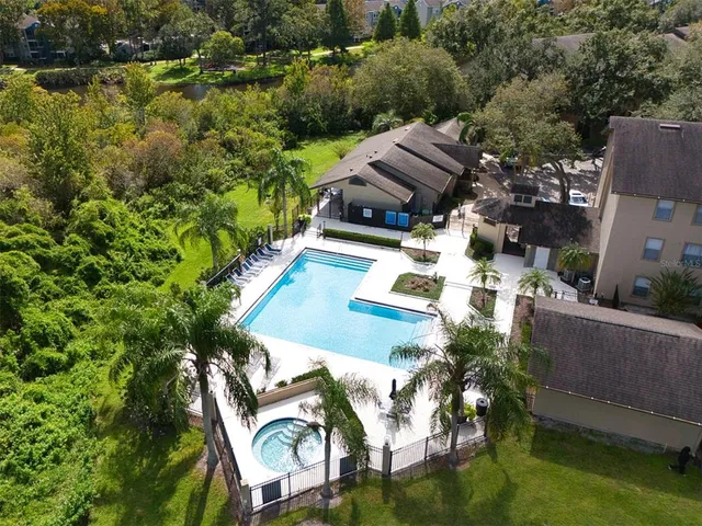 an aerial view of multiple houses with yard