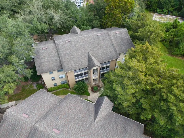 a aerial view of a house with porch and garden