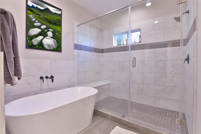 a bathroom with a bathtub and a shower