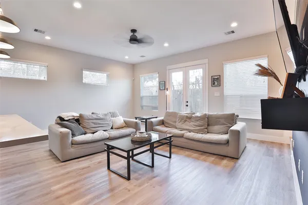 a living room with furniture and a wooden floor