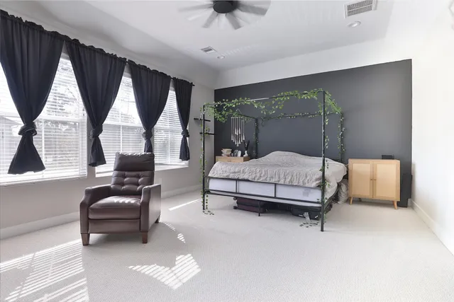 a bedroom with a bed couch and window