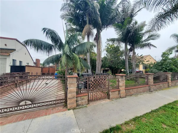 a view of a patio with iron fence