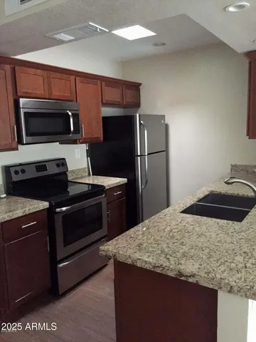 a kitchen with a sink and stainless steel appliances