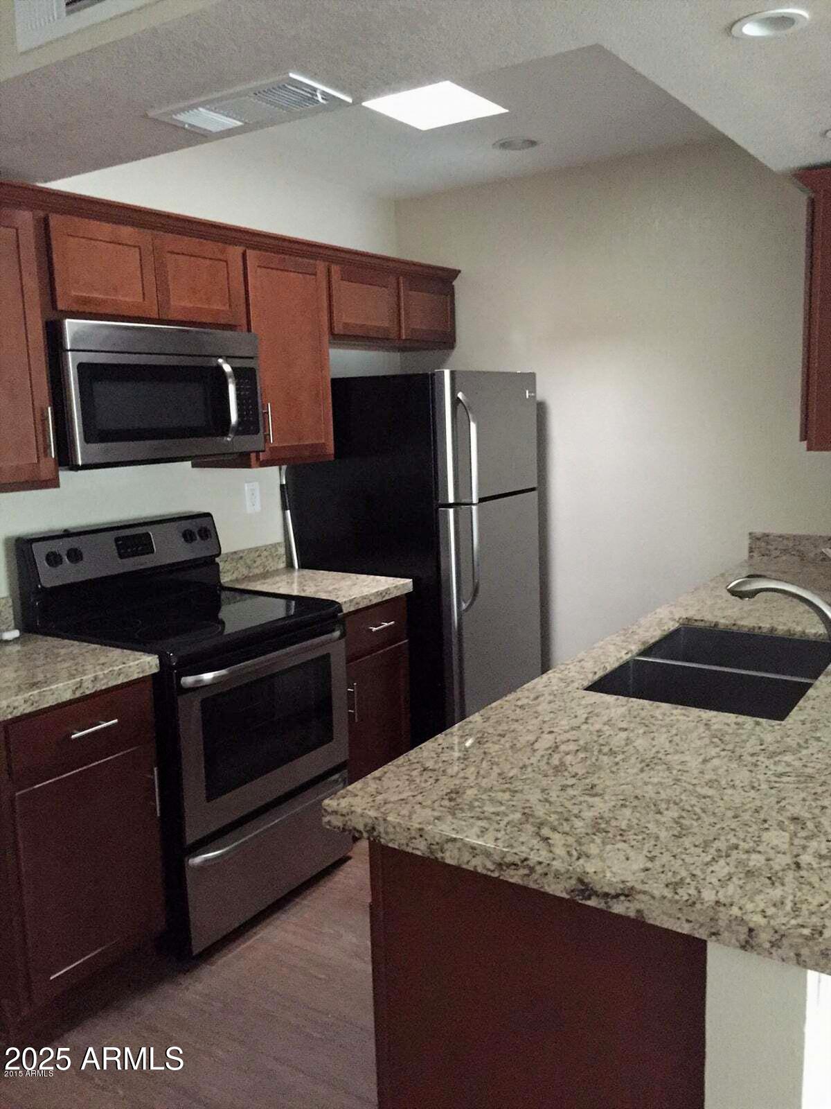 4540 North 44th Street, Unit 47 Phoenix, AZ 85018 - Photo 4 of 16 a kitchen with a sink and stainless steel appliances