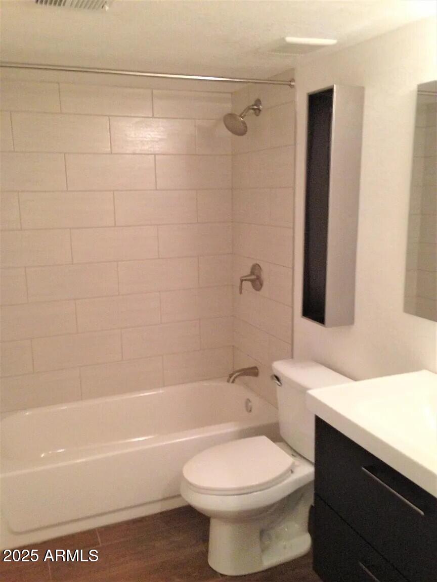 4540 North 44th Street, Unit 47 Phoenix, AZ 85018 - Photo 6 of 16 a bathroom with a sink a toilet and a bathtub